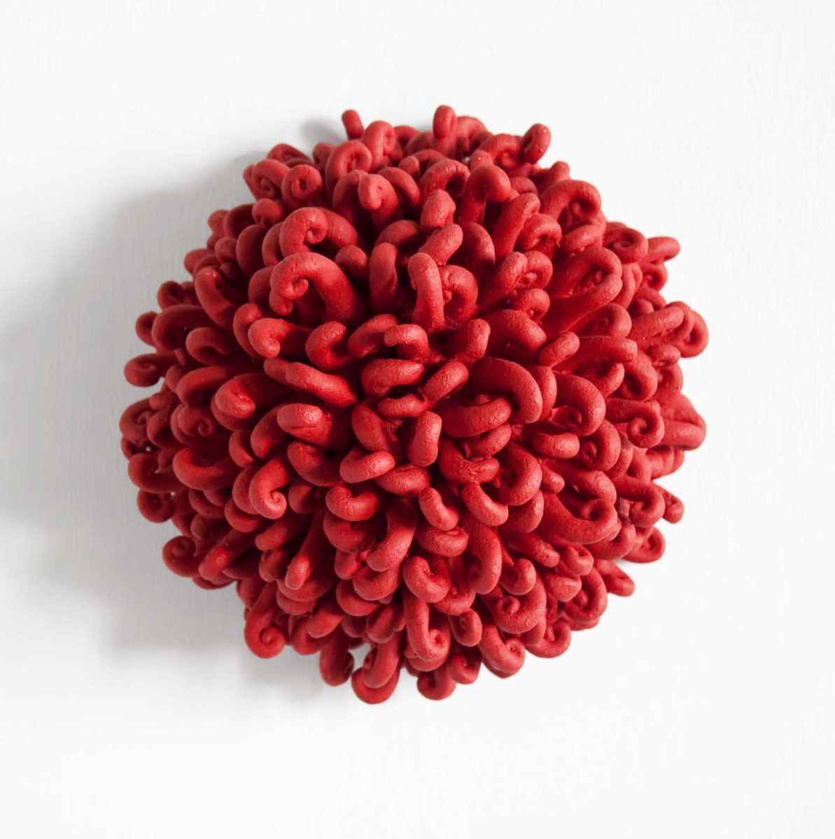 The force 2003, Sculpture by Kazumasa Mizokami, many red curled tentacle shaped objects making a hemisphere shape and appears to start moving.