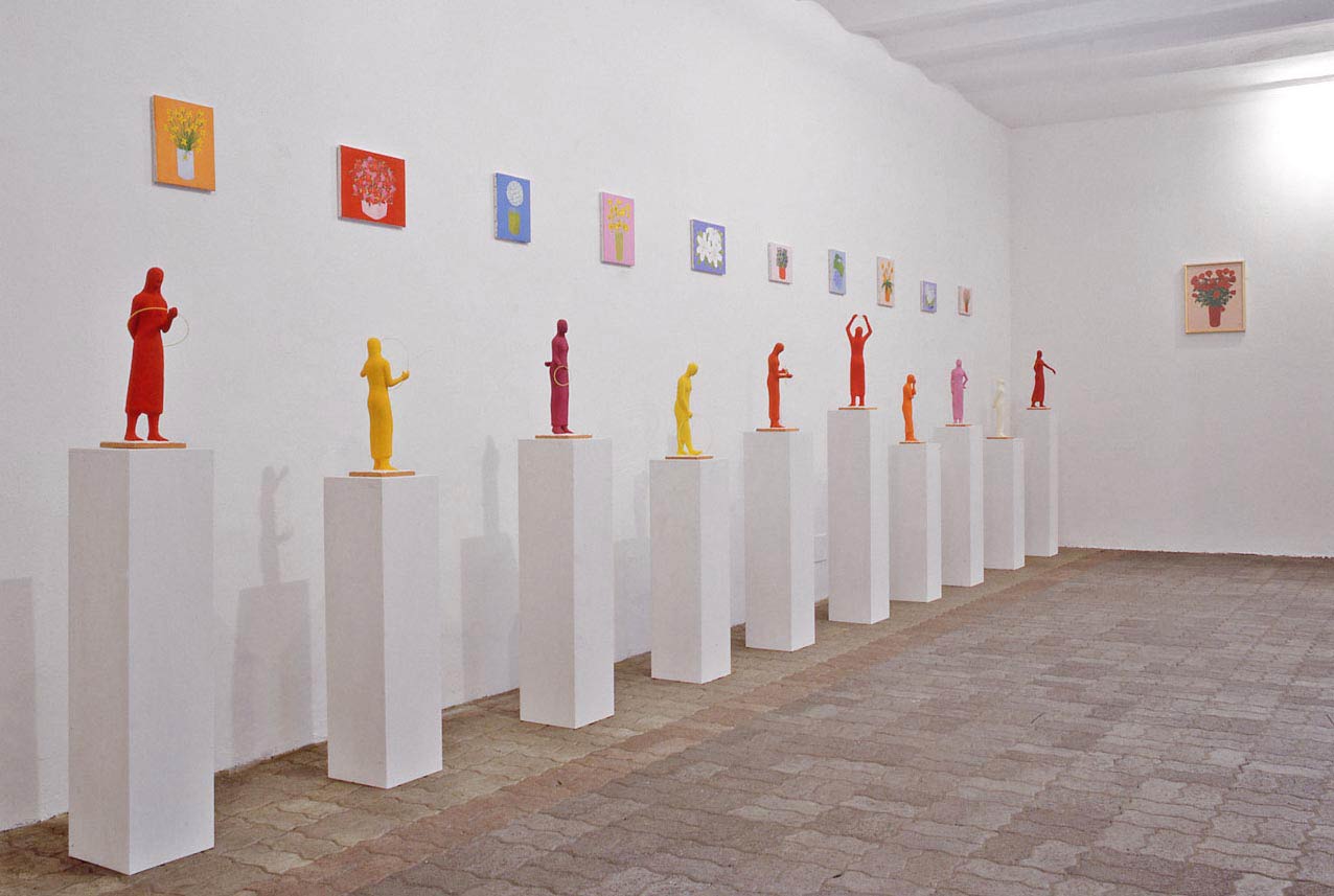 A exhibition of Kazumasa Mizokami, Ca 'di fra' in Milan 1998 in the same year. There are 10 red colored female figures with rings and small colored flowers on the wall. photo by Claudio Composti