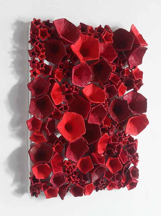 The sky-ninth noon Left view, Sculpture by Kazumasa Mizokami, Large and small red morning glory shaped objects methodically applied on the rectangular base.Left view