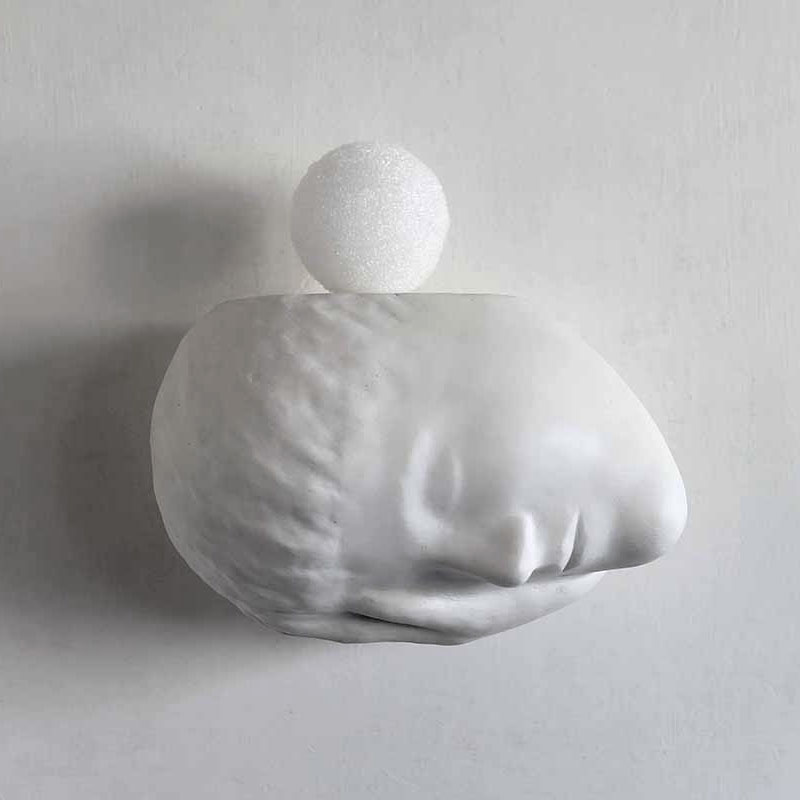 A work called The white night make by Kazumasa Mizokami in 2002. A sculpture with the white ball on the head of a sleeping boy in white gezzo