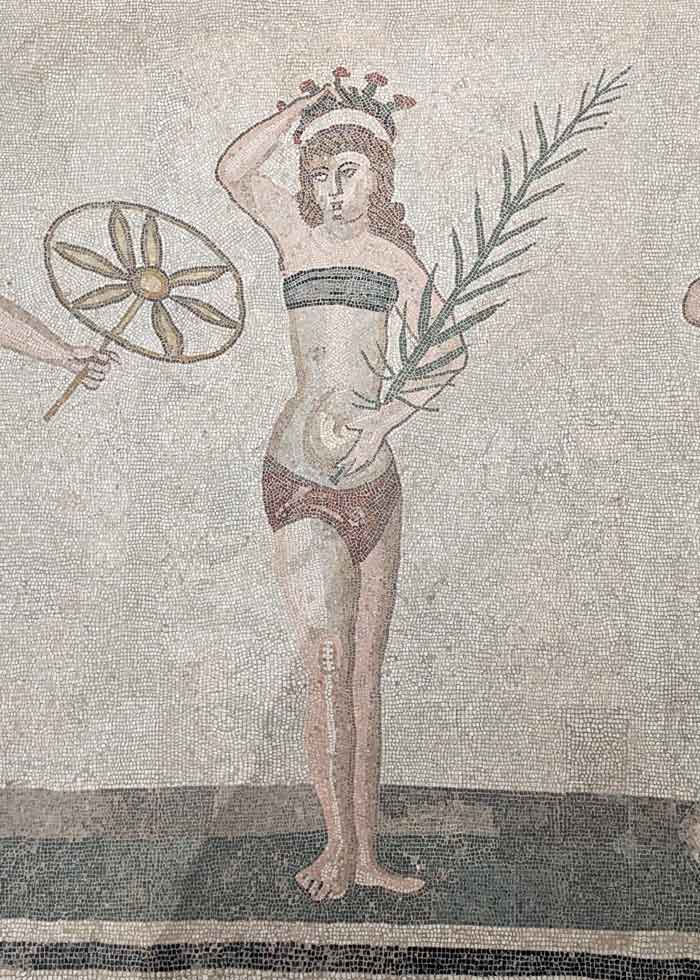 a woman in a bikini holding a crown and an olive branch made from mosaico di Villa Romana del Casale