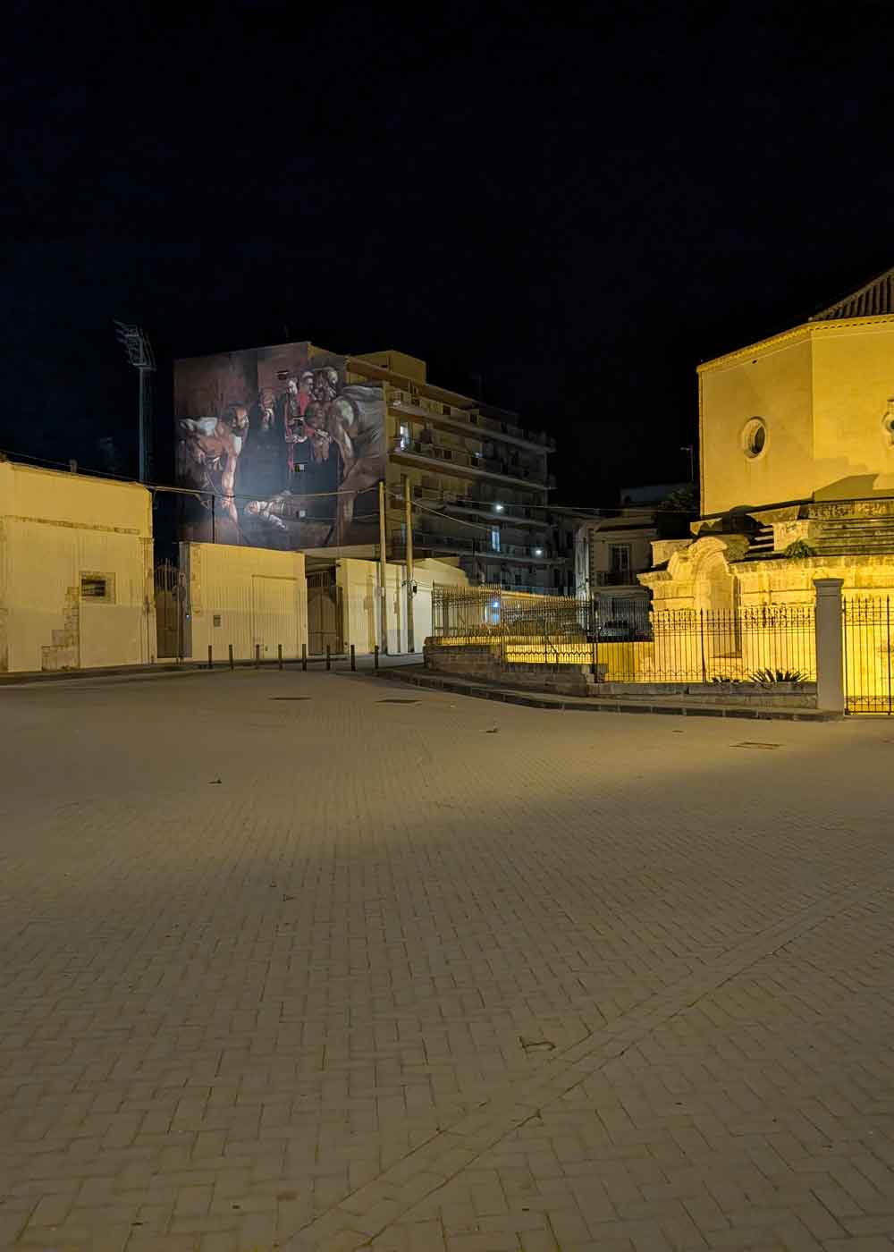 Night landscape seen from a park Santuario di Santa Lucia al Sepolcro. In the background, you can see a copy of Caravaggio's painting.