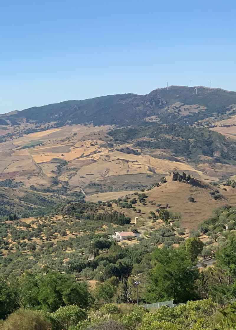 From the upper part of Troina you can admire a low, tree-lined hilly landscape, on the right, where there is an ancient abandoned church.